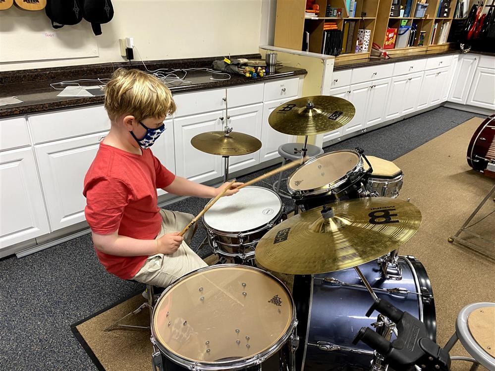 4th Grade student playing the drums