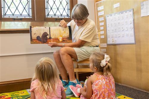 Teacher reading to young students